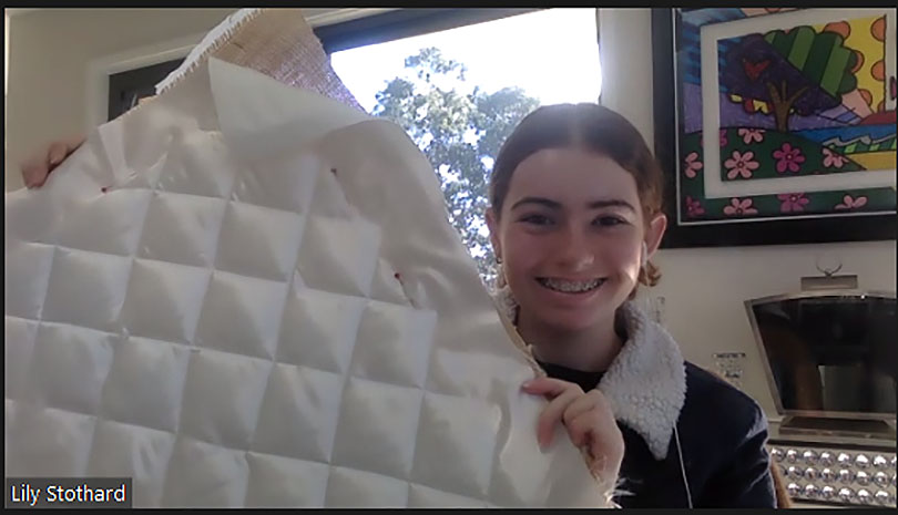 Lily Stothard showing her quilting to her mentor Tom Isaacs